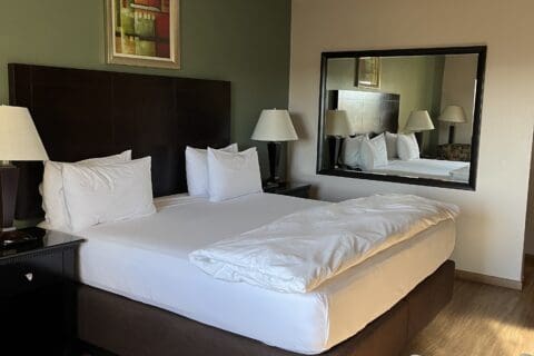 Hampshire king bed with white linen sheets and cover