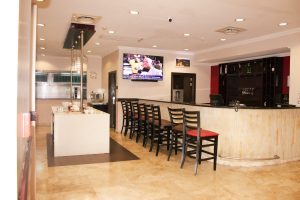Hampshire hotel bar with chairs facing the bar to be serve with drinks of your choice